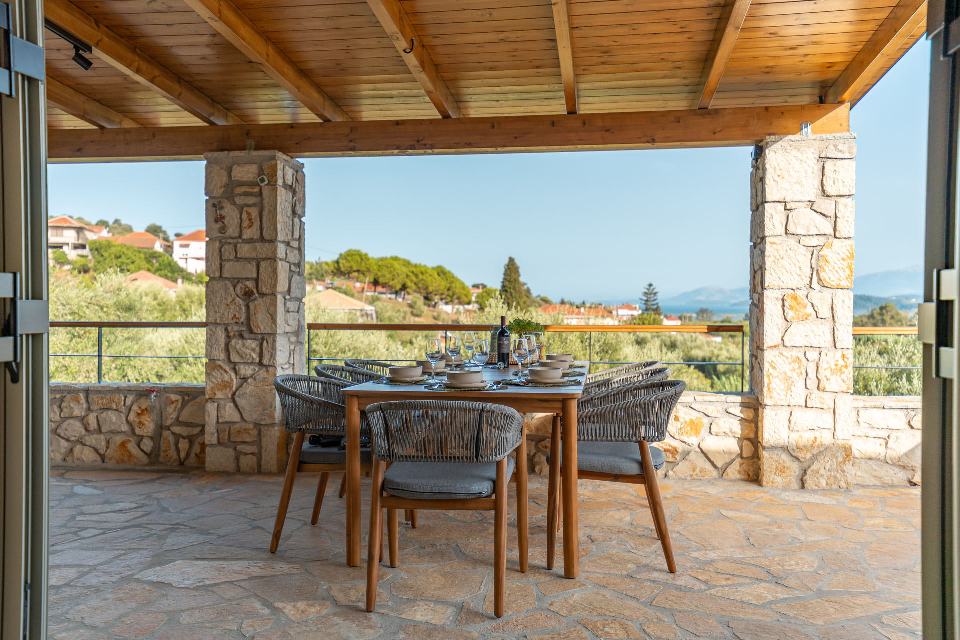 The covered veranda, dining with a view over the olives to the gulf
